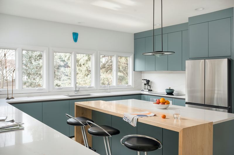 Installed Zecchinon kitchen with sage-green fronts and an oak breakfast bar