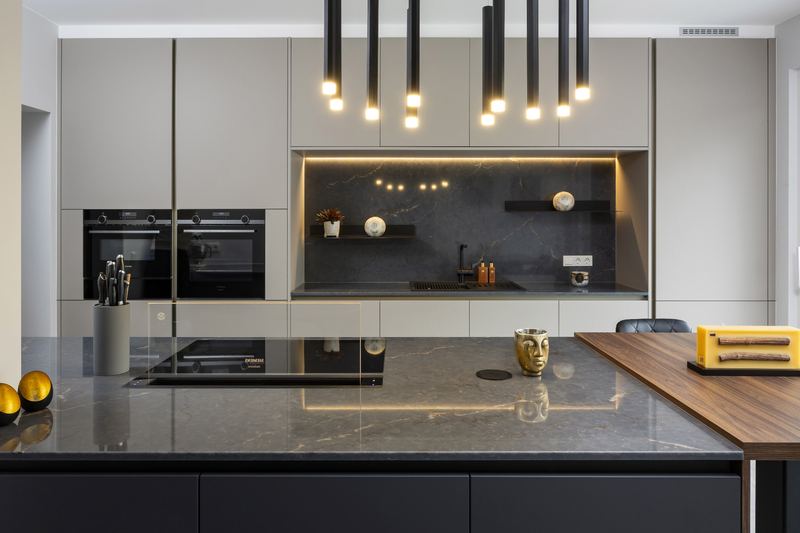 Installed Zecchinon kitchen with a dark stone island and pendant lights